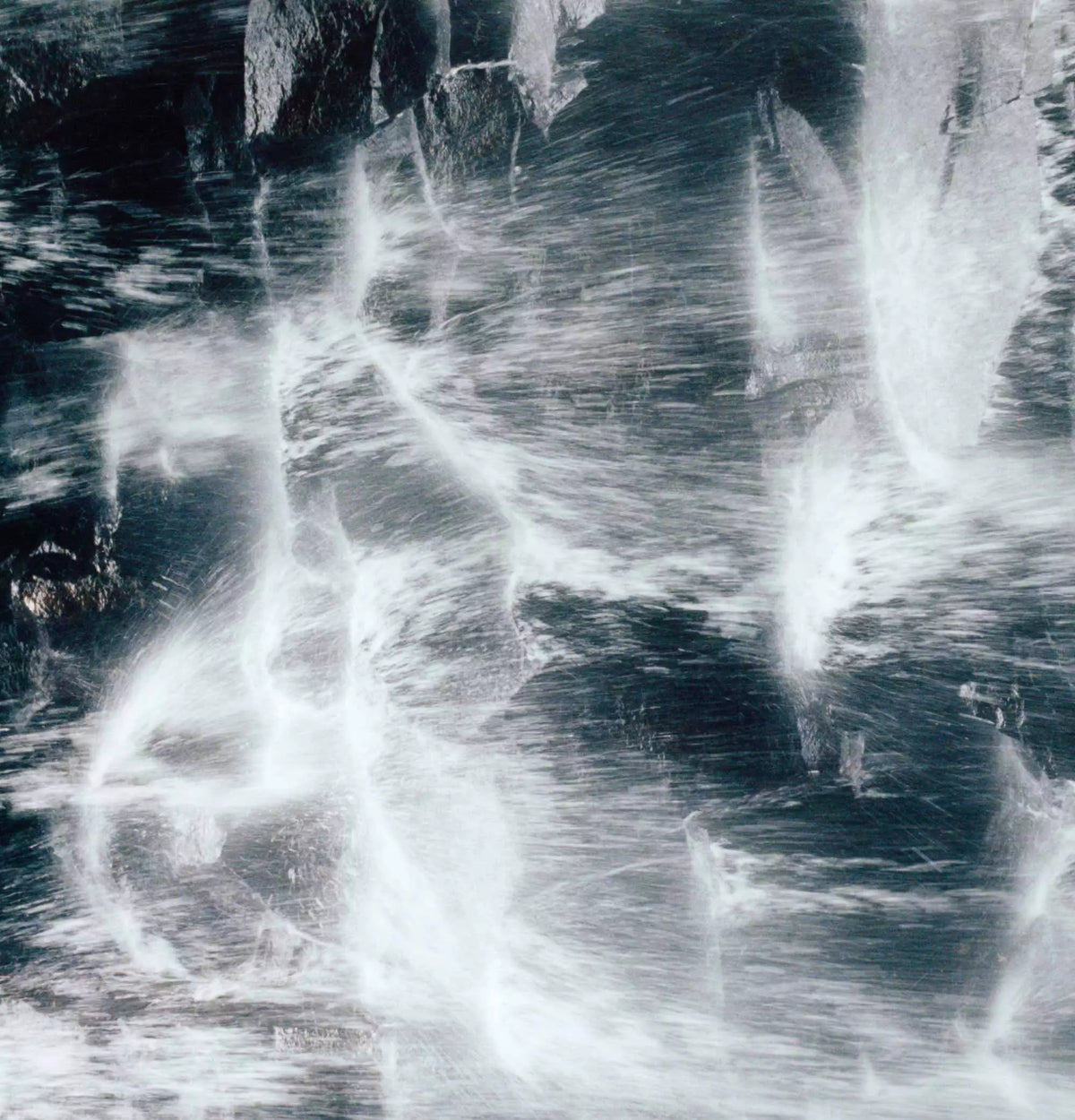 Close-up of foaming water in blue and white tones.
